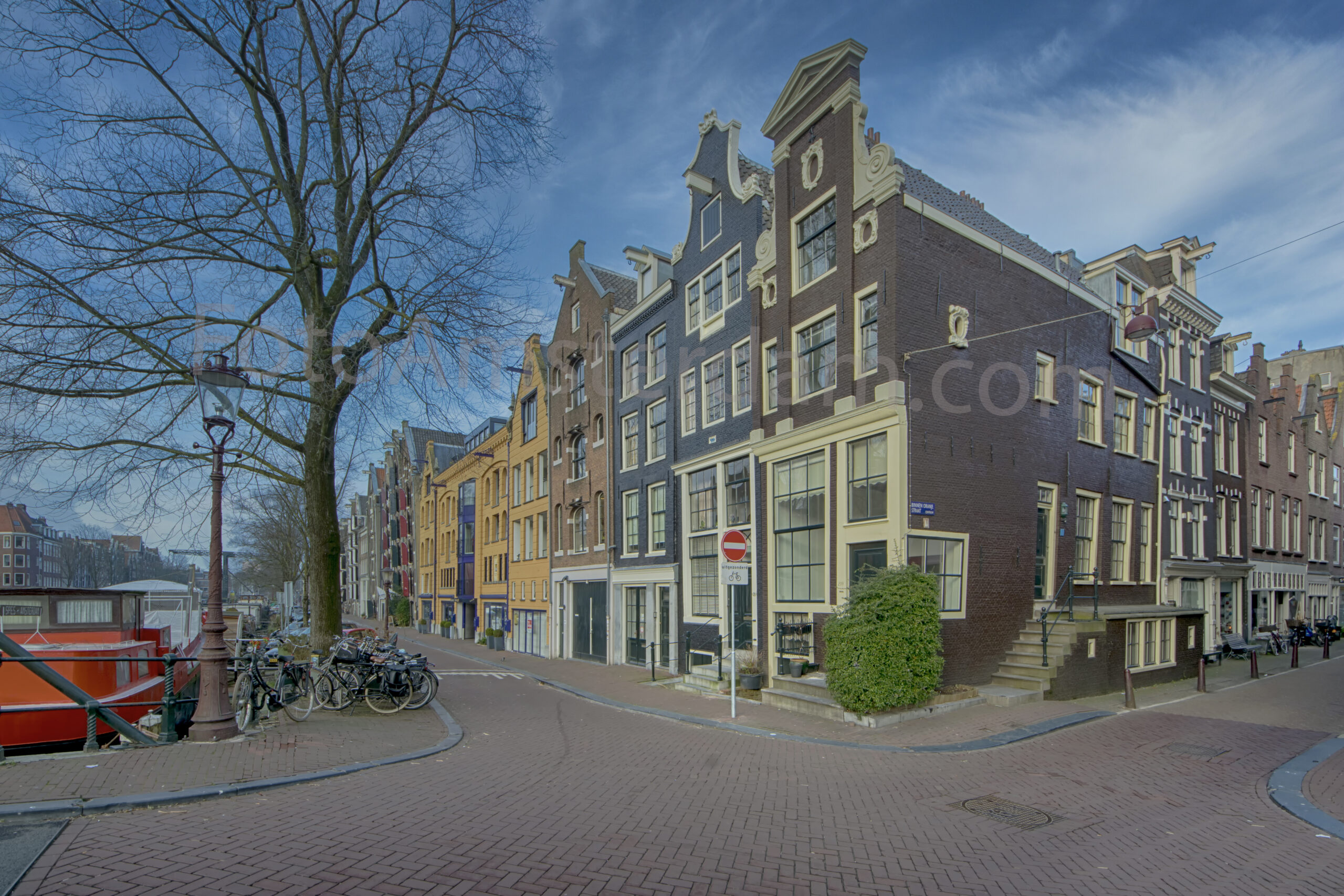 Historic merchant houses on Brouwersgracht beneath a dramatic winter sky in Amsterdam