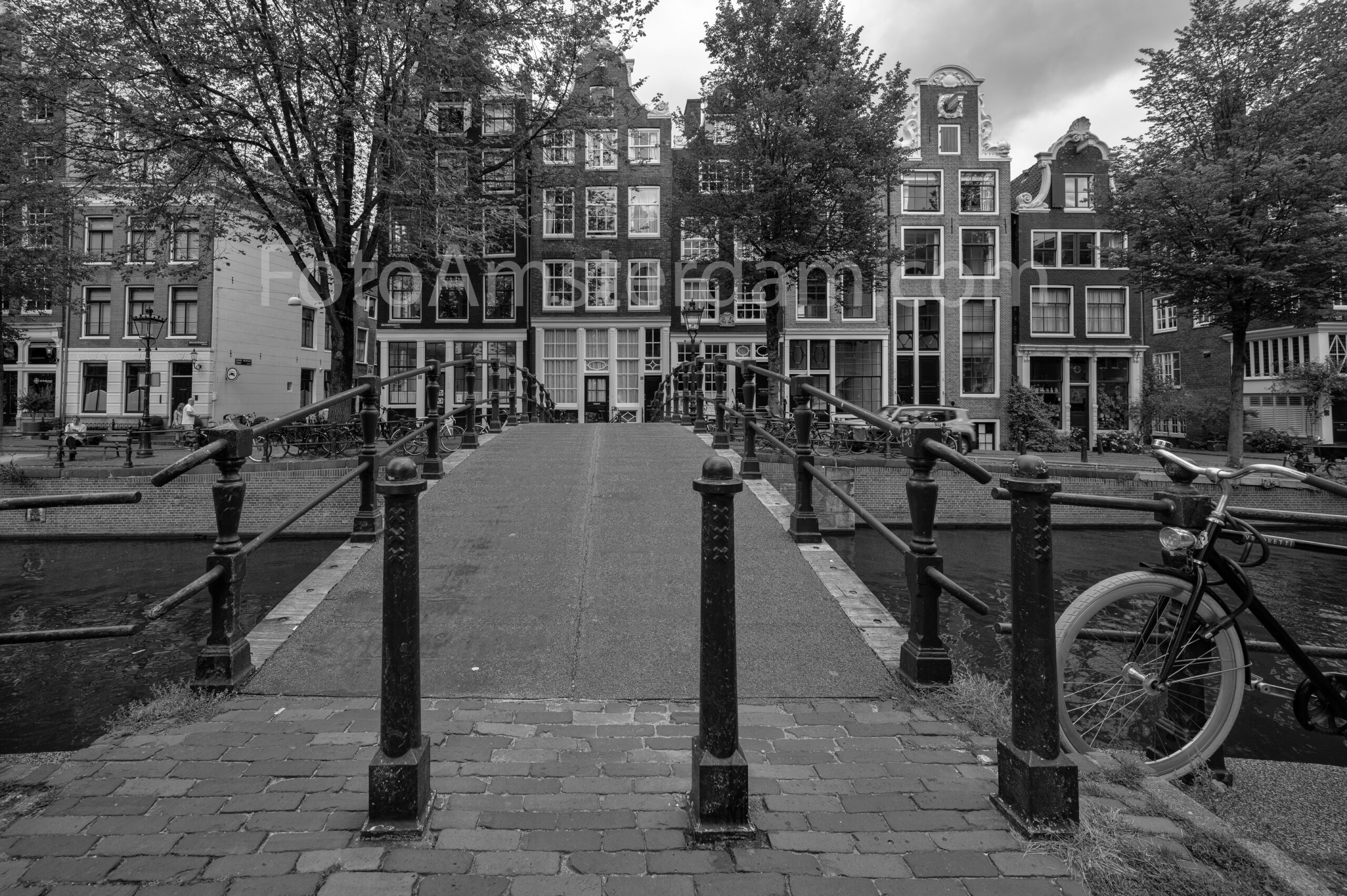 Black and white photograph of Brouwersgracht with historic canal houses and bridge in Amsterdam
