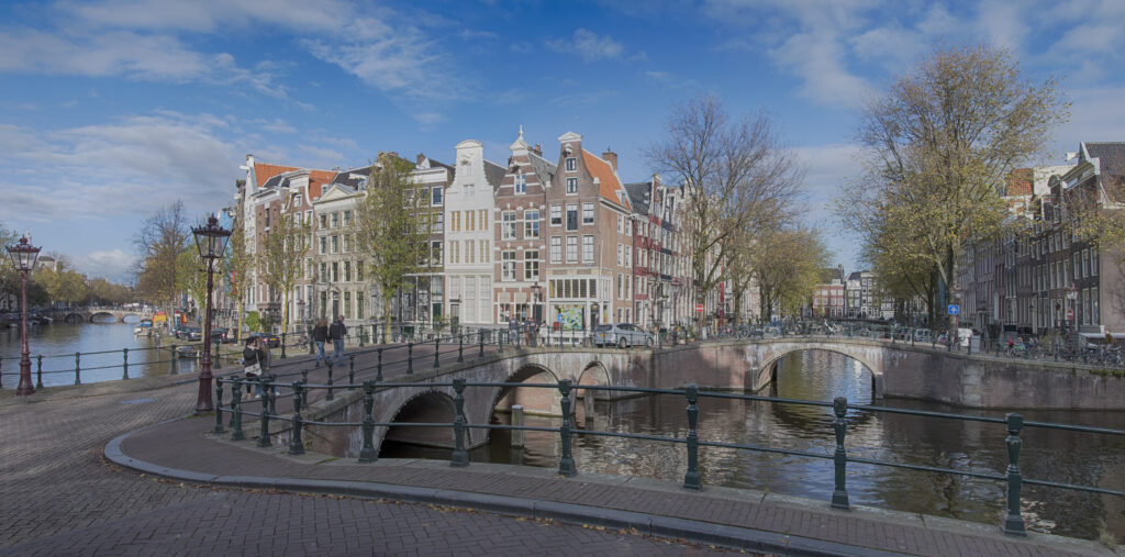 Keizersgracht Amsterdam with elegant canal houses and historic bridge on a sunny day