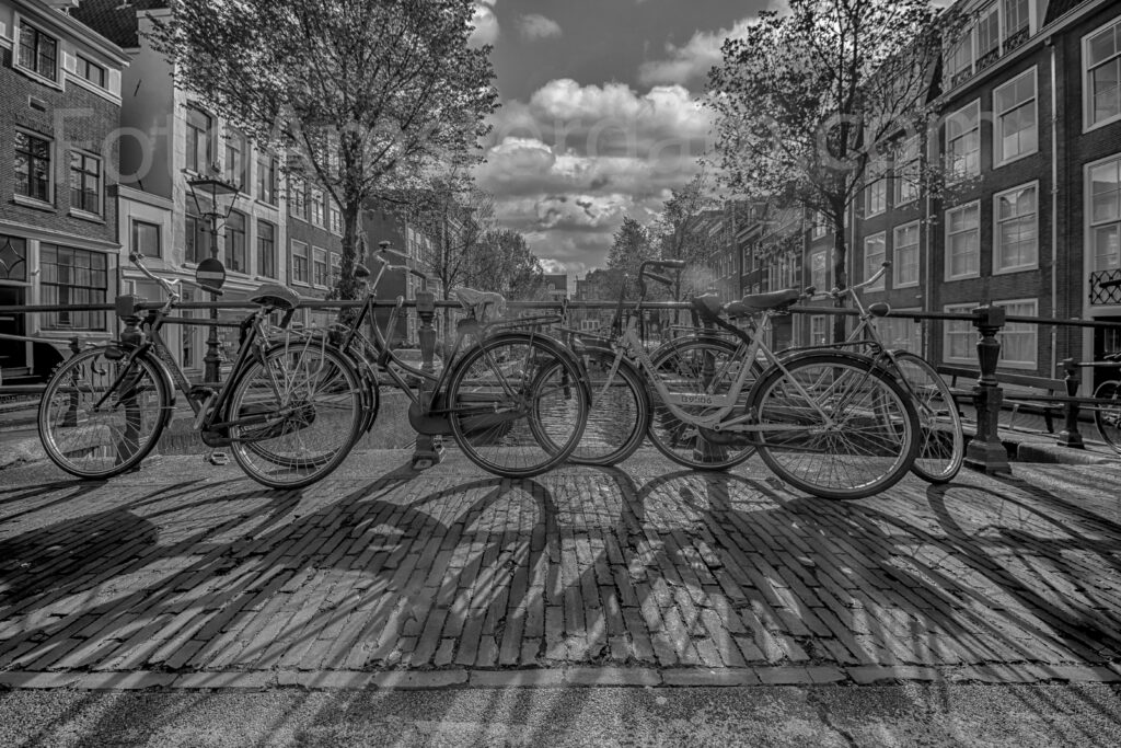 Bicycles on a bridge across the Keizersgracht capturing everyday life in Amsterdam