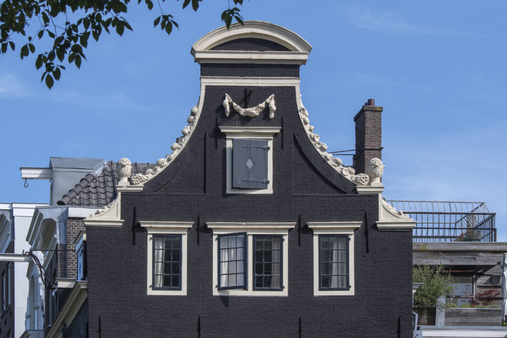 Decorative gable detail on a historic canal house along the Herengracht.