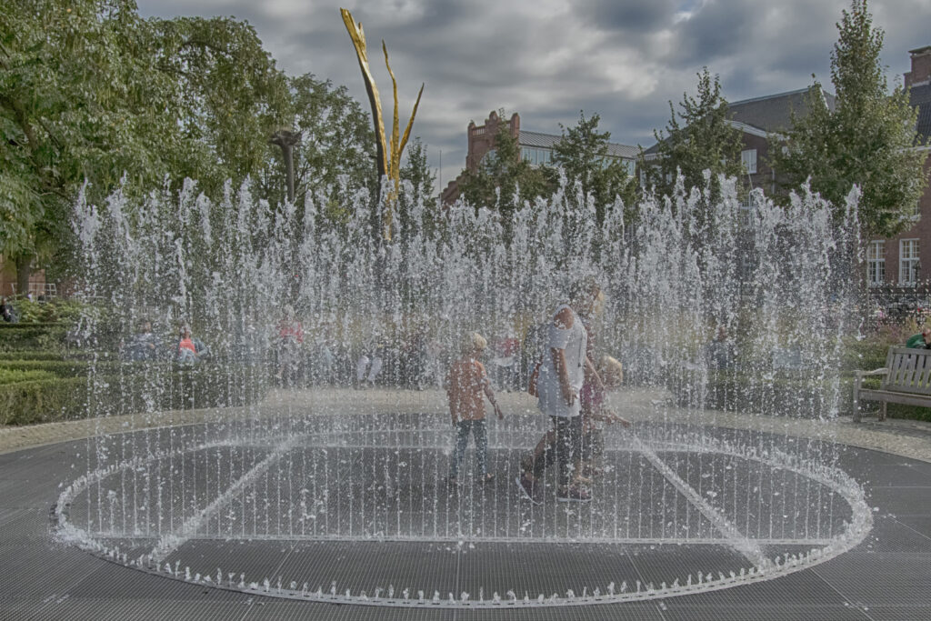 Children playing in the fountains at Museumplein during summer