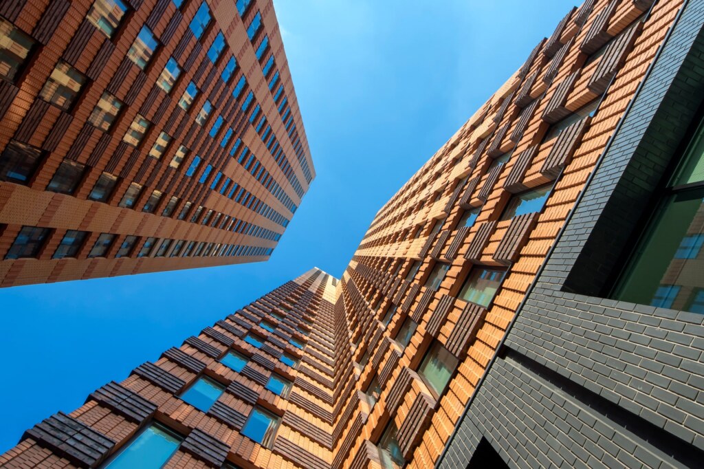 Looking up between the Symphony buildings in Amsterdam with dramatic diagonal lines